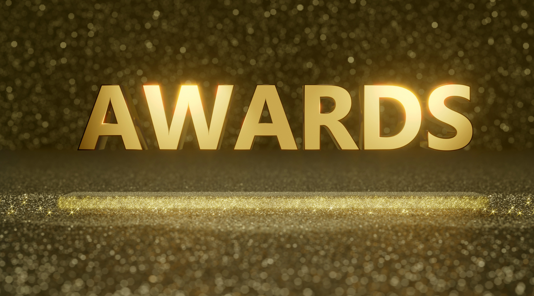 image of the word awards in gold representing custom company rings and how awarding employees makes for a lasting impression. 